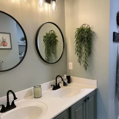 Finished bathroom vanity, mirror, lighting and tiled shower area