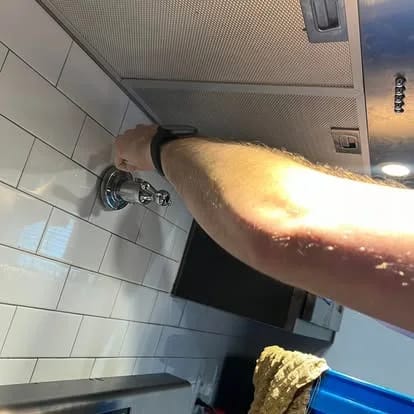 Installed shower controls and fixture on a tiled wall