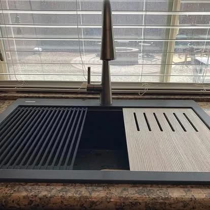 Installed dark workstation sink and high-arc faucet